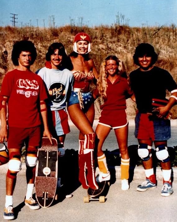 Lynda Carter on her skateboard poses with skateboarders 24x36 inch poster